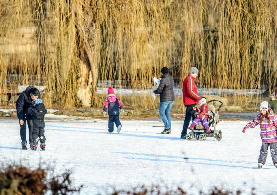 people having fun on a frozen pond