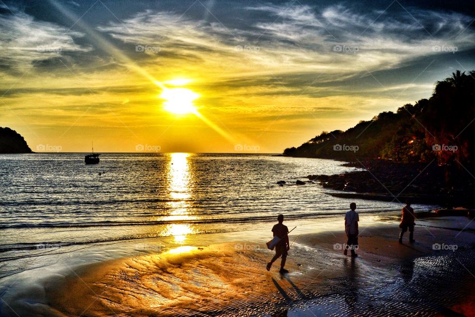 Fisherman at the beach. Sunset