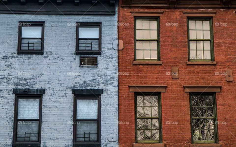 A building complex with split colors of blue and red brick 