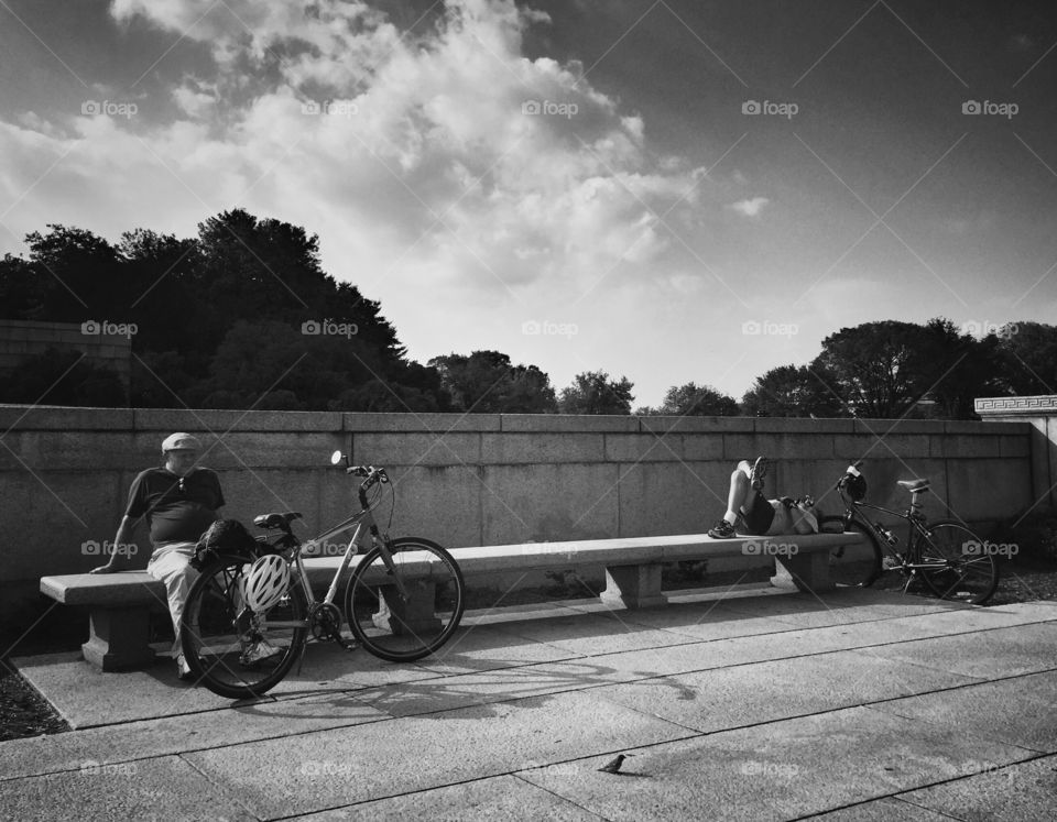 Cyclists relaxing on bench at Lincoln Memorial 