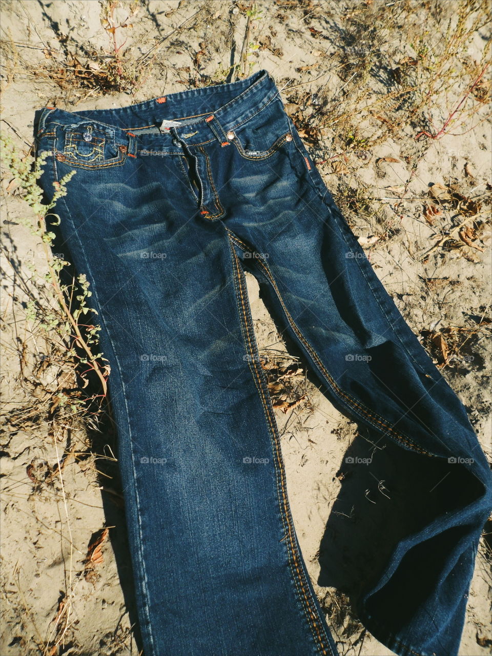 jeans lie on sand