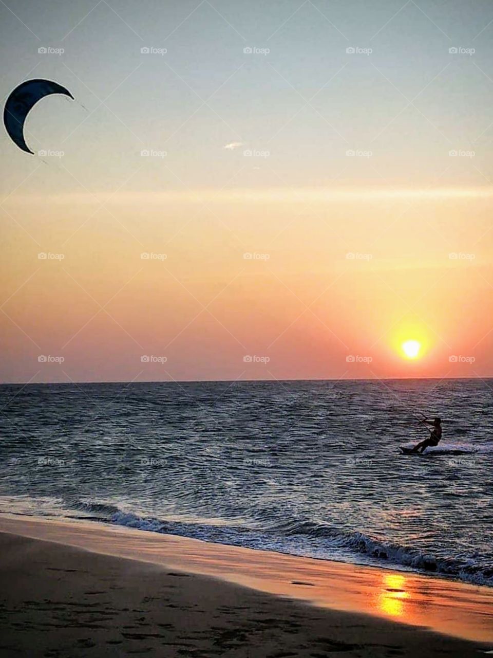 Kitesurfe at Sunset on beach of Jericoacora, Brazil 