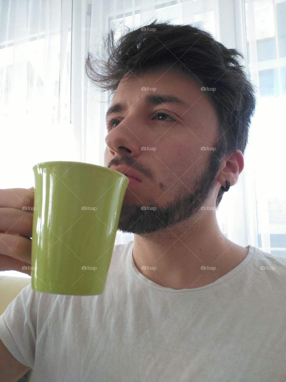 drinking a mug of hot tea