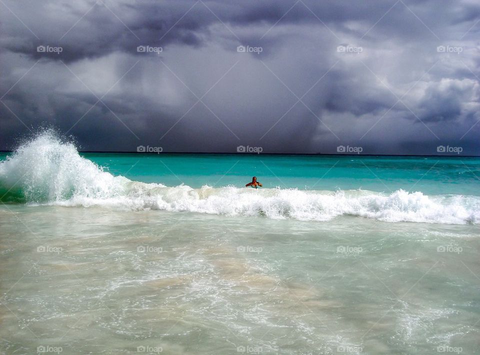 Person surfing in sea, Riviera Maya