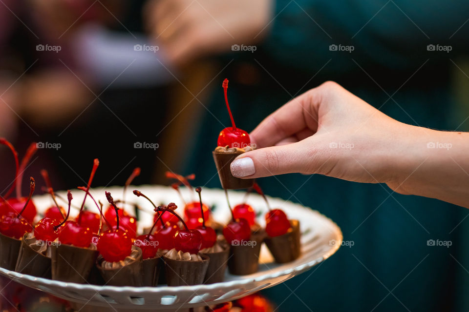 A woman catching a cherry candy 
