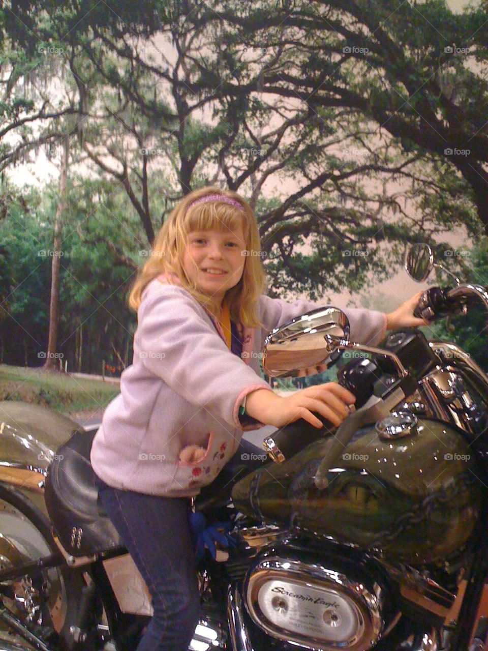 She’s loving the chance to sit on a Harley in the Orlando Airport.