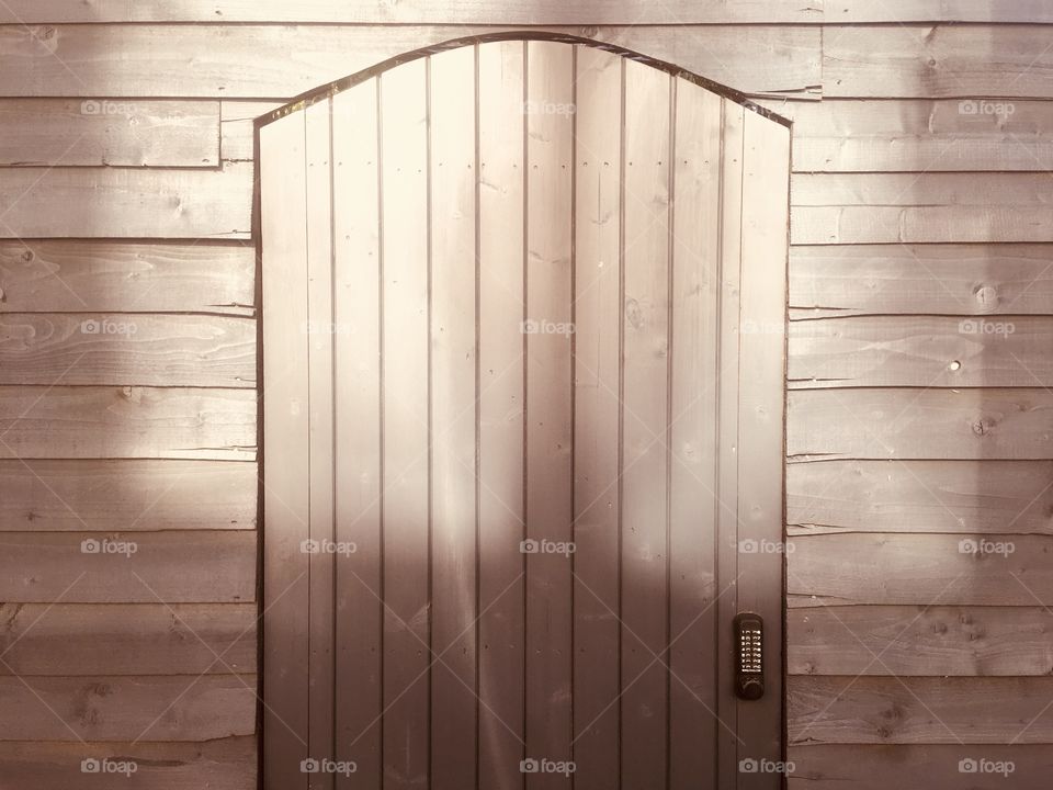 Wooden door with alphanumeric keypad entry, on Kipling Street, Southwark, London, in Spring.