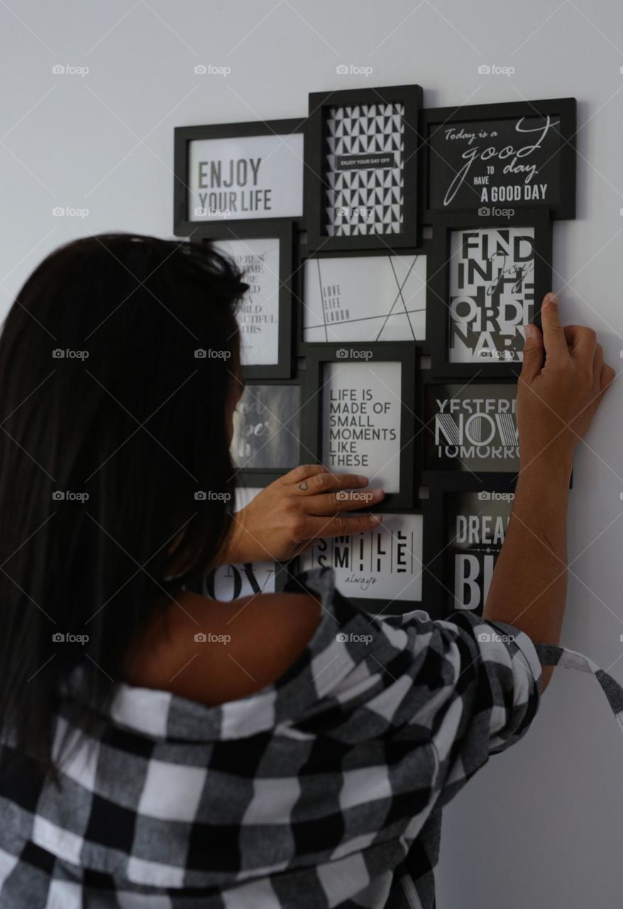 girl hangs frames at home, rectangular shape