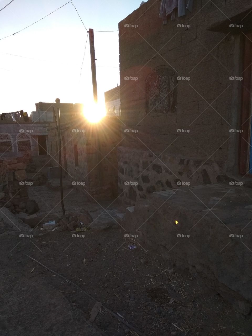 Catching the sun at uncomplate hole at rooftops of old rural buildings.