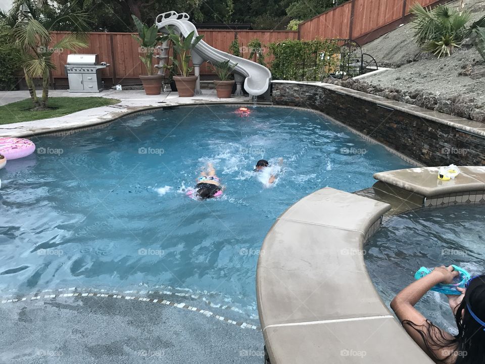 Friends swimming in our pool. 
