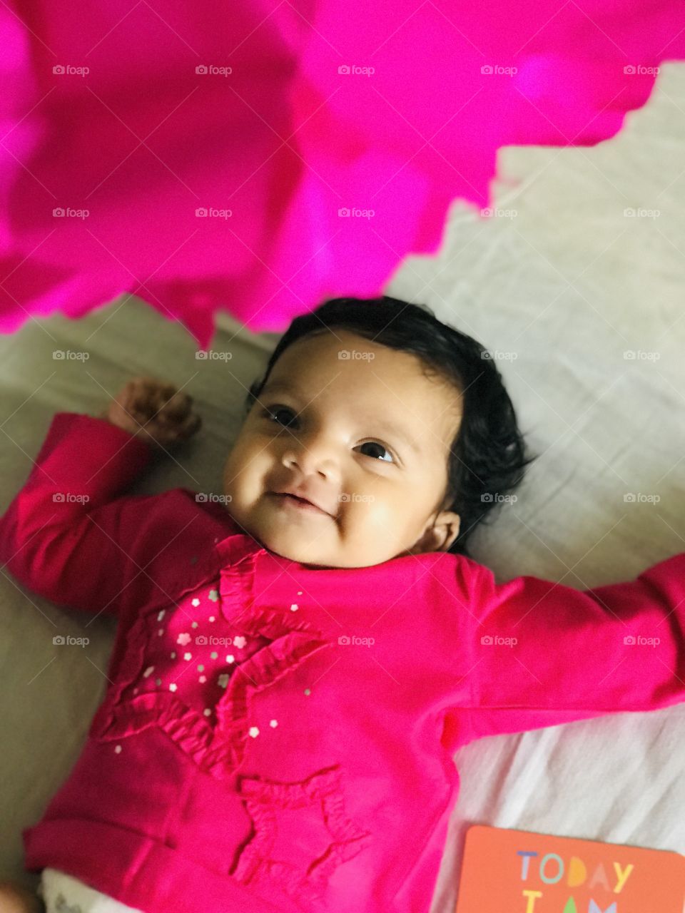 My baby in bright pink colour dress with cute smile.