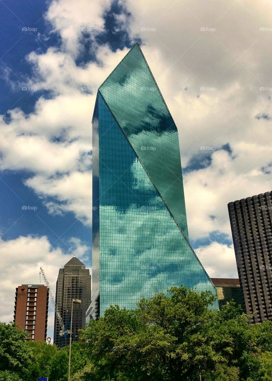 Glass Skyscraper in Downtown Dallas Texas reflecting clouds