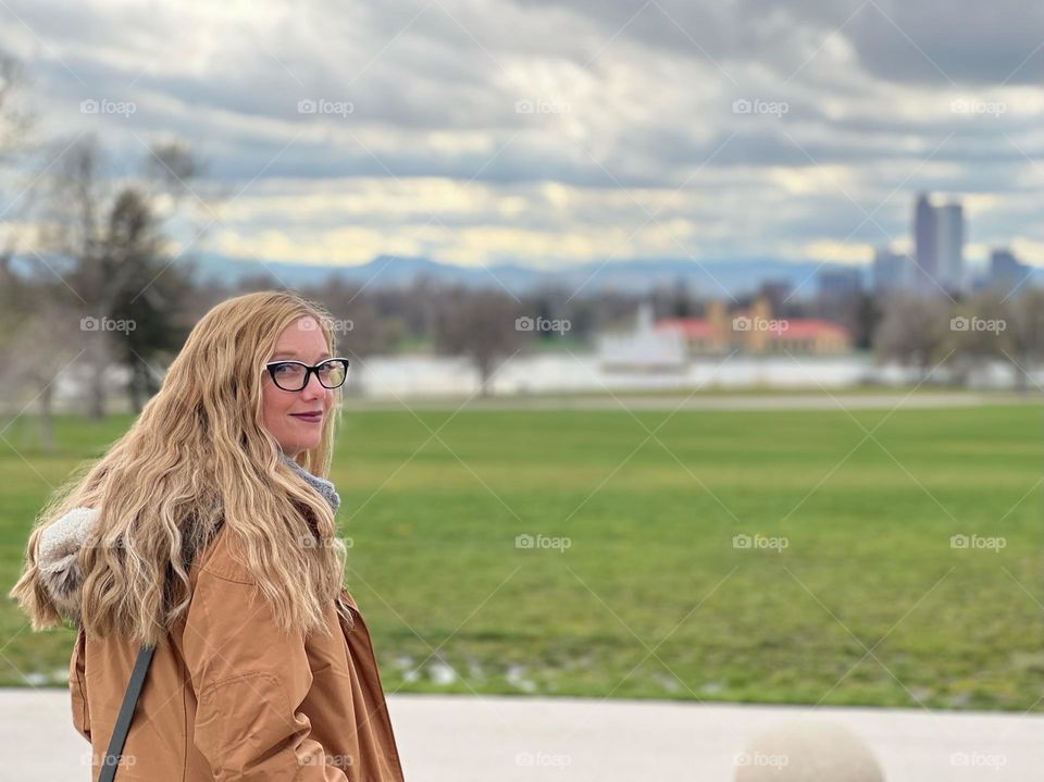 A woman with long blonde wavy hair exploring a new city