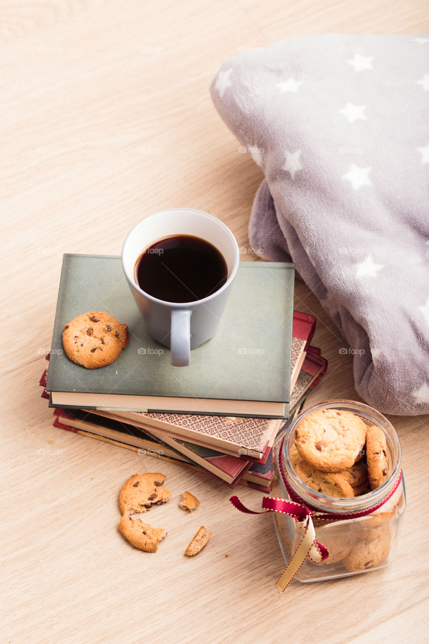 A few books with cup of coffee and cookies on wooden floor. Time for relax. Spending leisure time on reading. Cozy and comfortable. Relaxing 😌