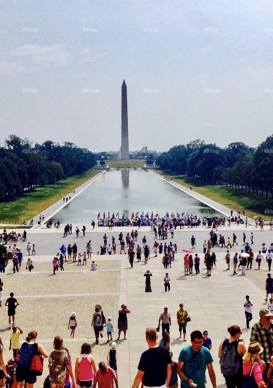 Tourist visit the Washington Monument and the Reflecting Pond.