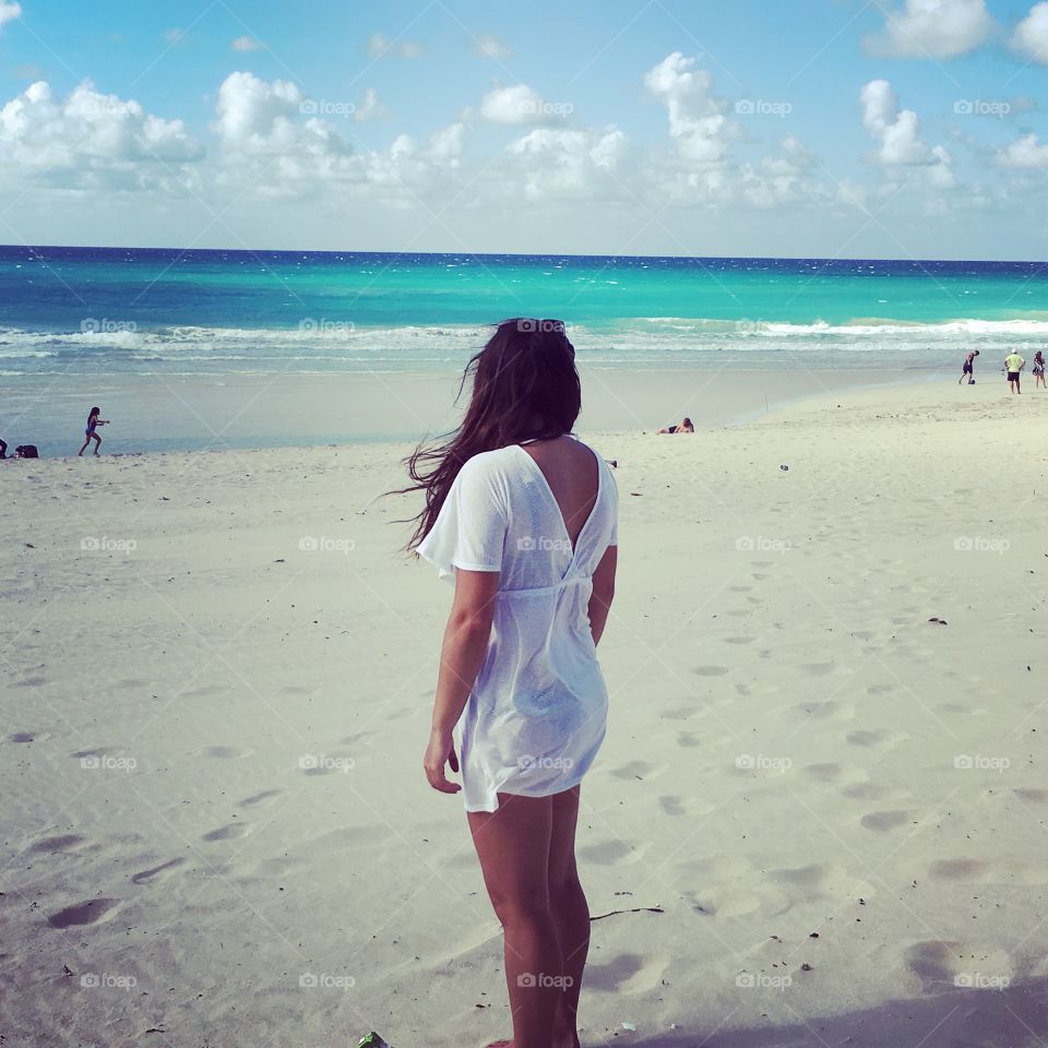 Girl looking out to beautiful turquoise sea 