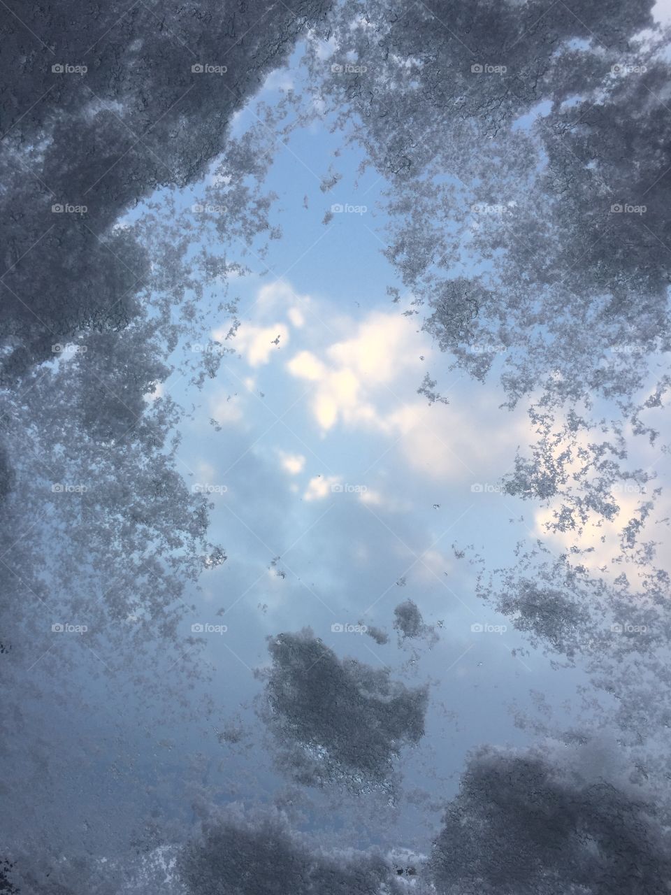 Clouds throw a snowed-in window