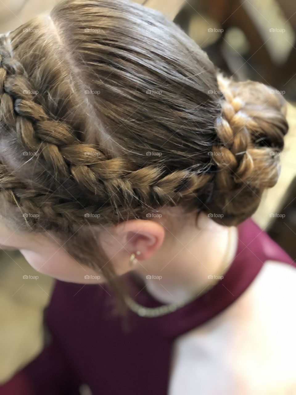 Beautiful amber brown hair braided in a bun