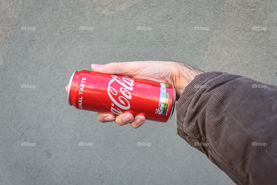 Holding Coca-Cola can for use