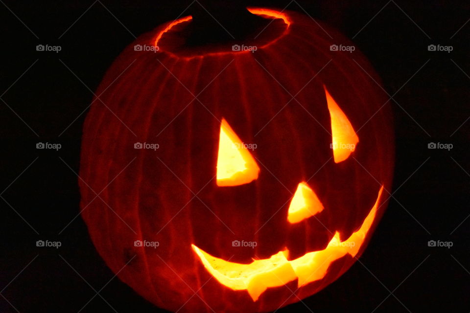 lit up carved pumpkin at night
