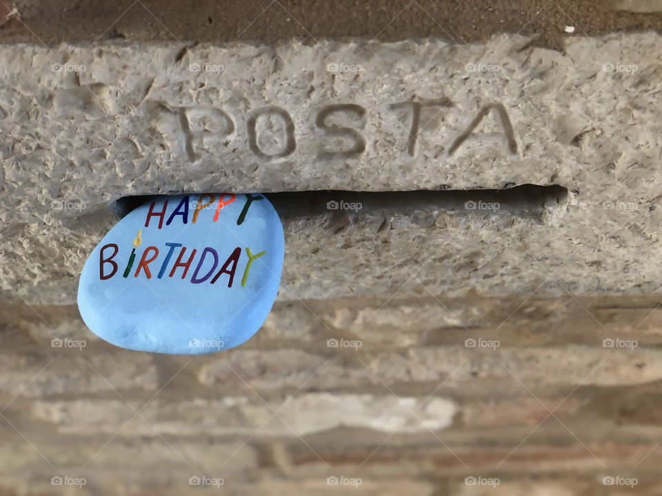 Happy Birthday stone like a letter in a mailbox hole