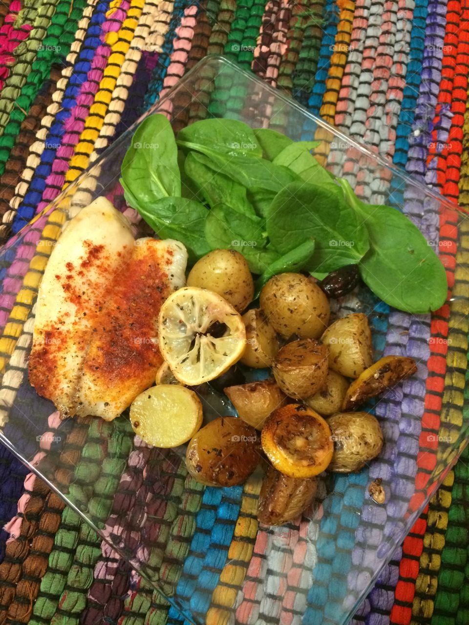 Fish Dinner. Tilapia fish, potatoes, spinach, and olives for a wholesome dinner