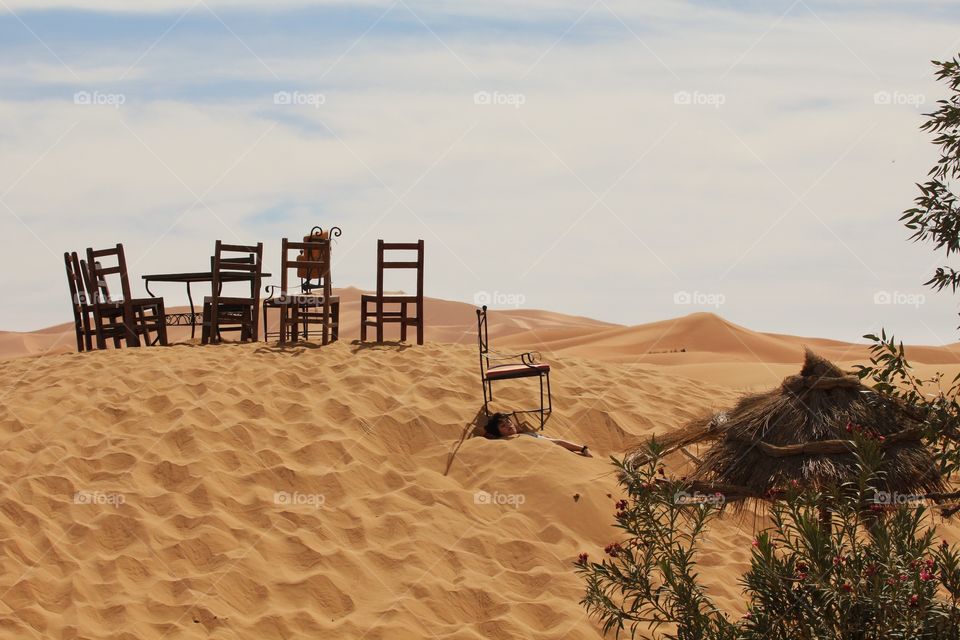 Boy playing in sand dunes in the Sahara 