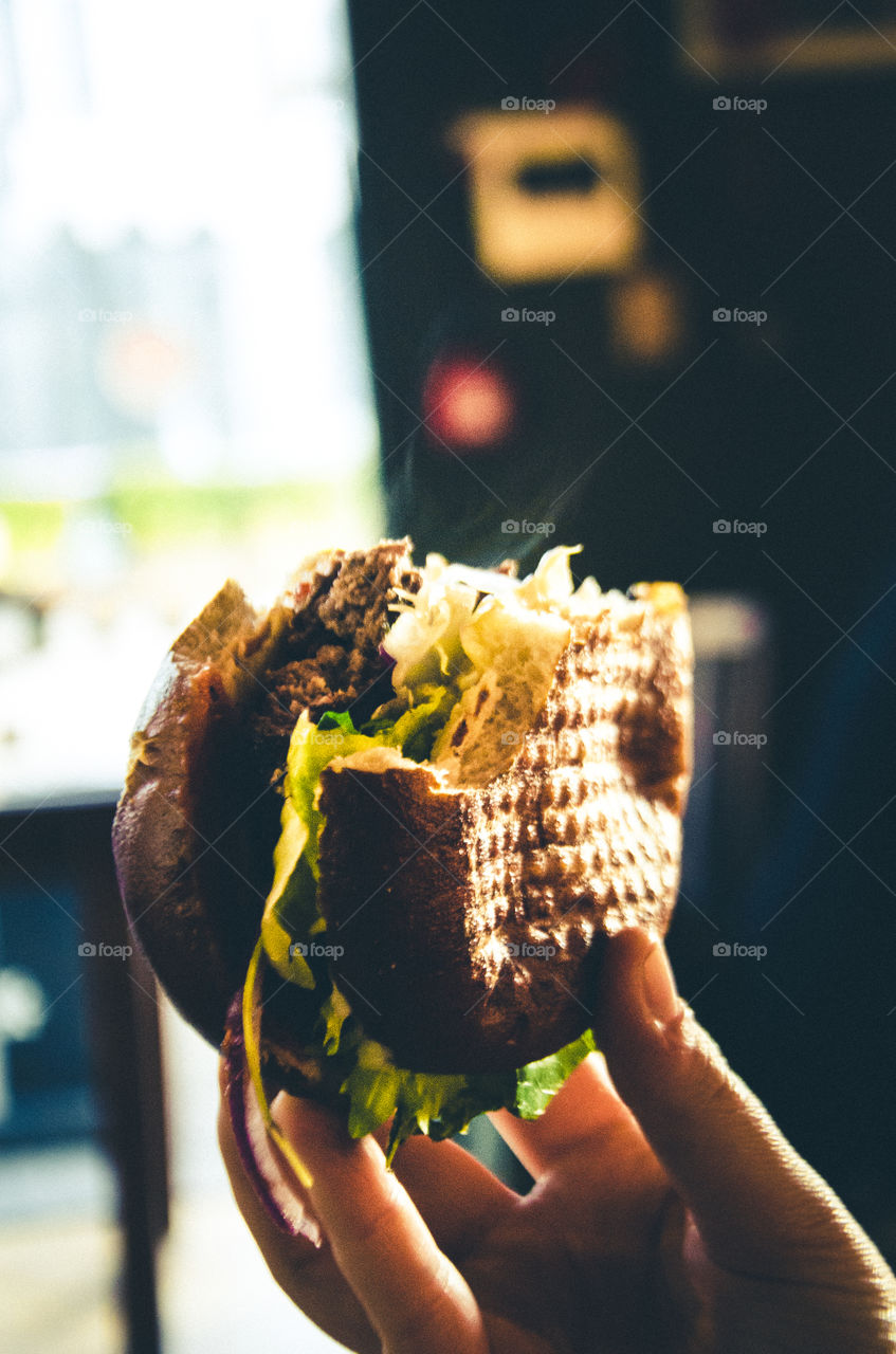 Close-up of hand holding burger