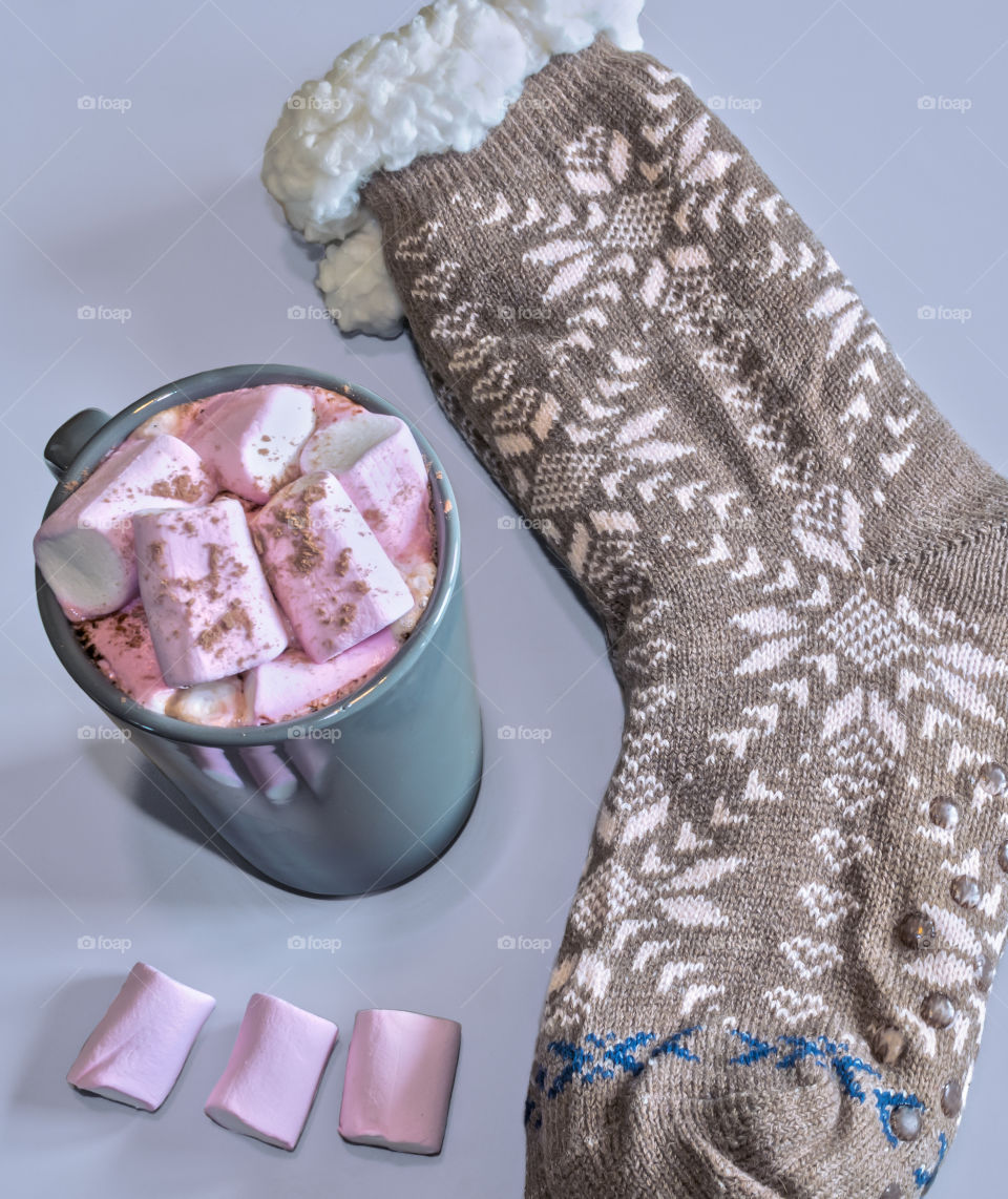 Hot chocolate with marshmallows and a pair of chunky woollen socks