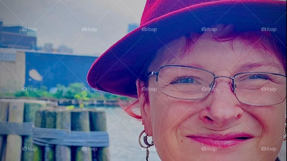 An extra close closeup of my comedic happy face just before I climb over the wall, go down the ladder and along the planks to get to my home on the ocean, a boat we call “Salvation” because it has given us just that. 2022. Hypnotic Productions