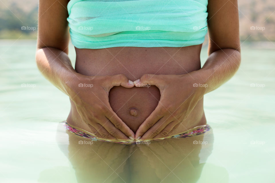 Pregnant women making heart shape