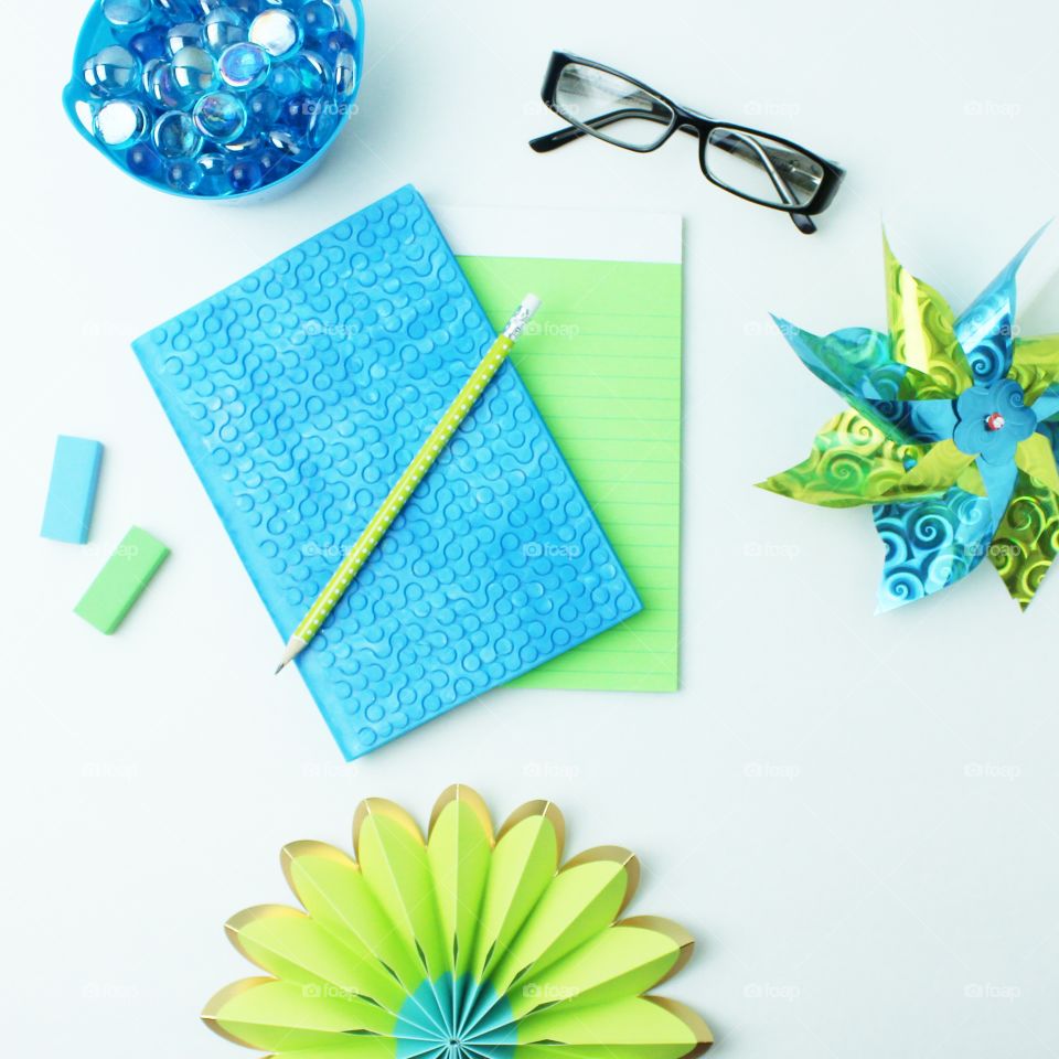 Blue and green notebook and notepad. spring theme flat lay
