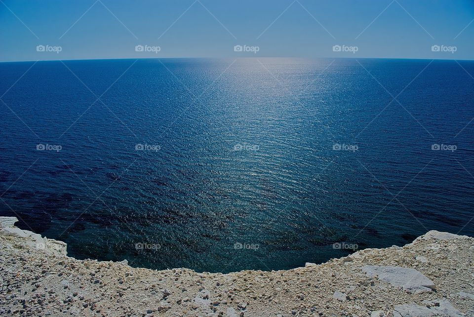 Deep blue Mediterranean from the edge of the cliff at Petra tou Romiou, Cyprus