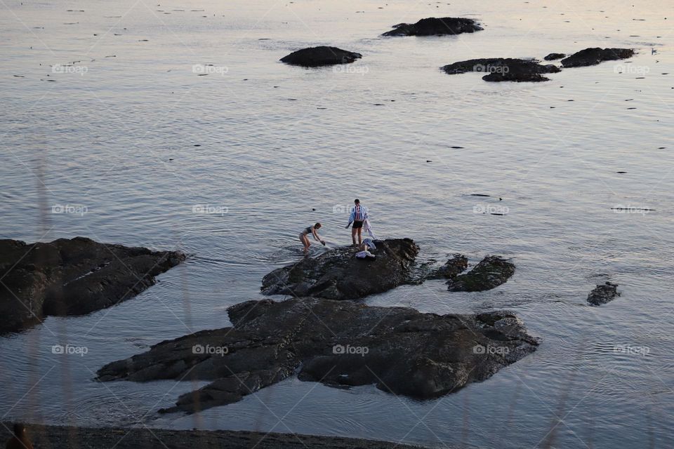 Couple on rocks after swimming 