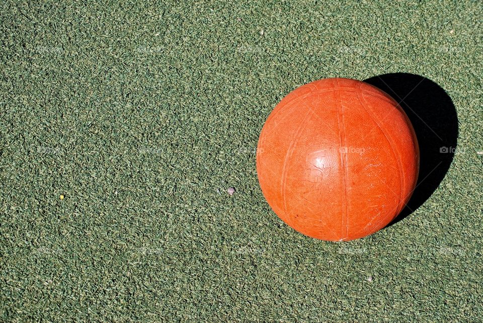 Basketball on green surface