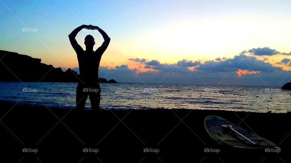 yoga and tai chi on the beach at sunset