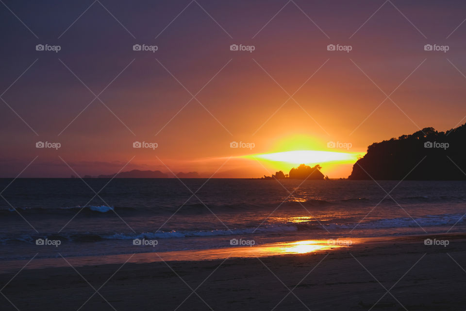 Sunset at the horizon in the sea