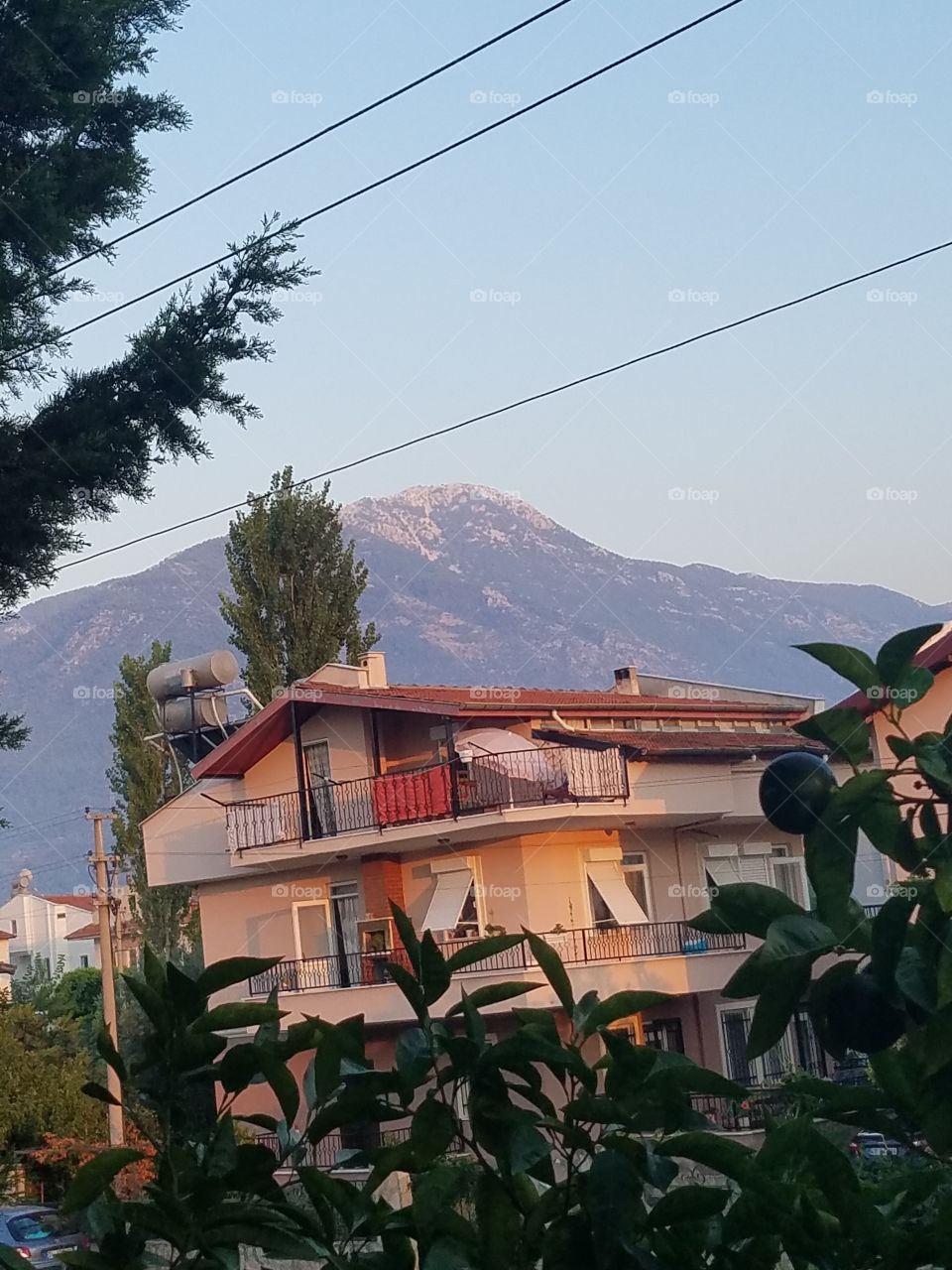 a house in fethiye turkey with mountains in the background