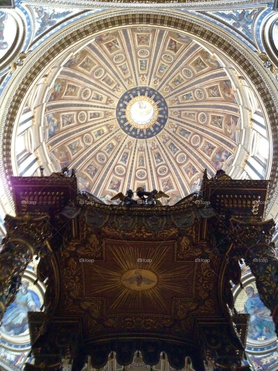 Bernini's baldacchino and interior of Michelangelo's dome of St Peter's Basilica in Vatican City