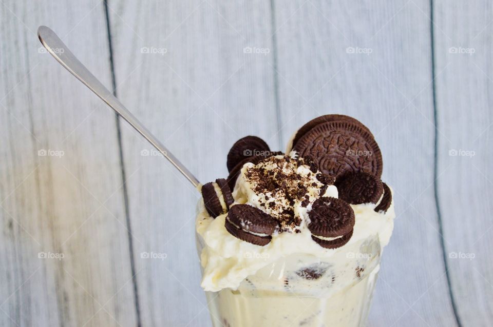 Oreo cookie milkshake with a wooden rustic white background