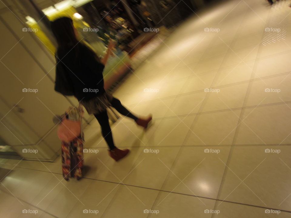 Tokyo, Japan.  Businesswoman Walking in Subway with Suitcase