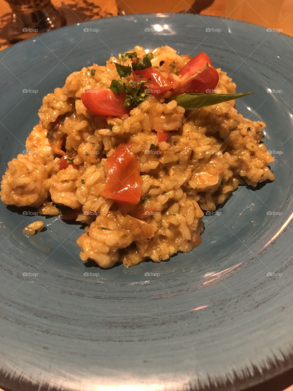 Delicious shrimp risotto in a blue dish