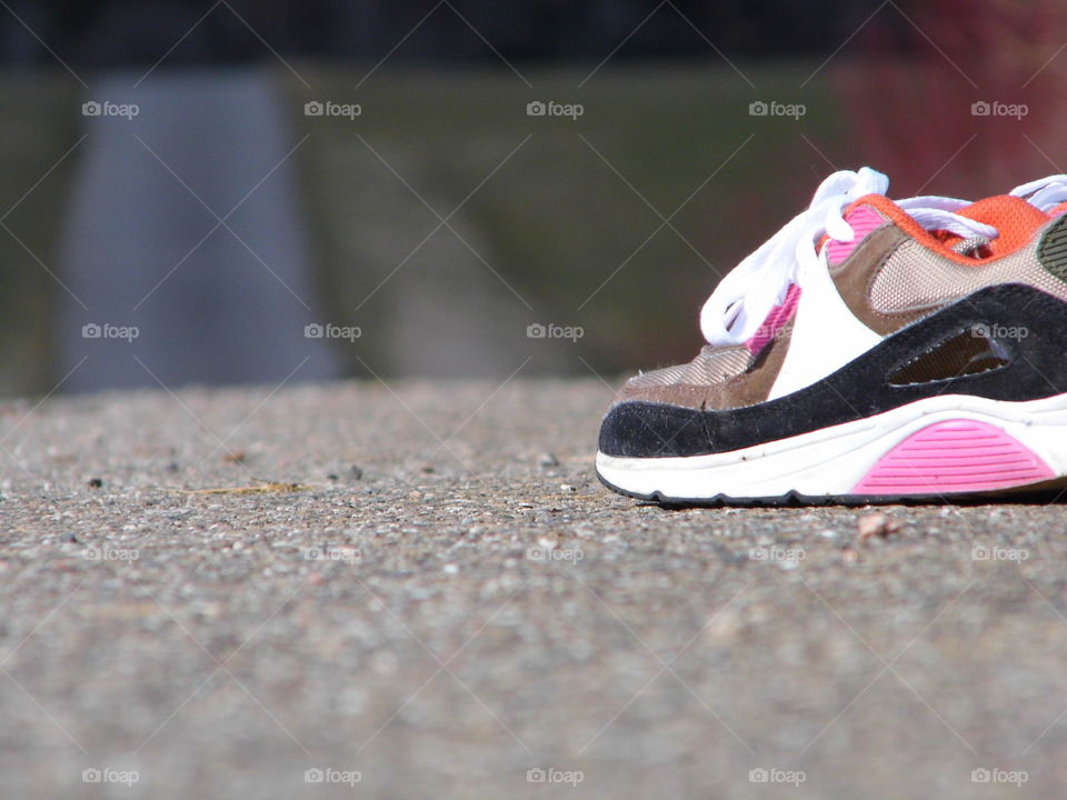 One pair of shoes placed on street and traveling with a pair of shoes