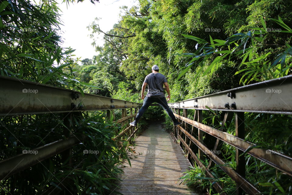 Walking across a bridge on our hike through the bamboo forest in Maui.