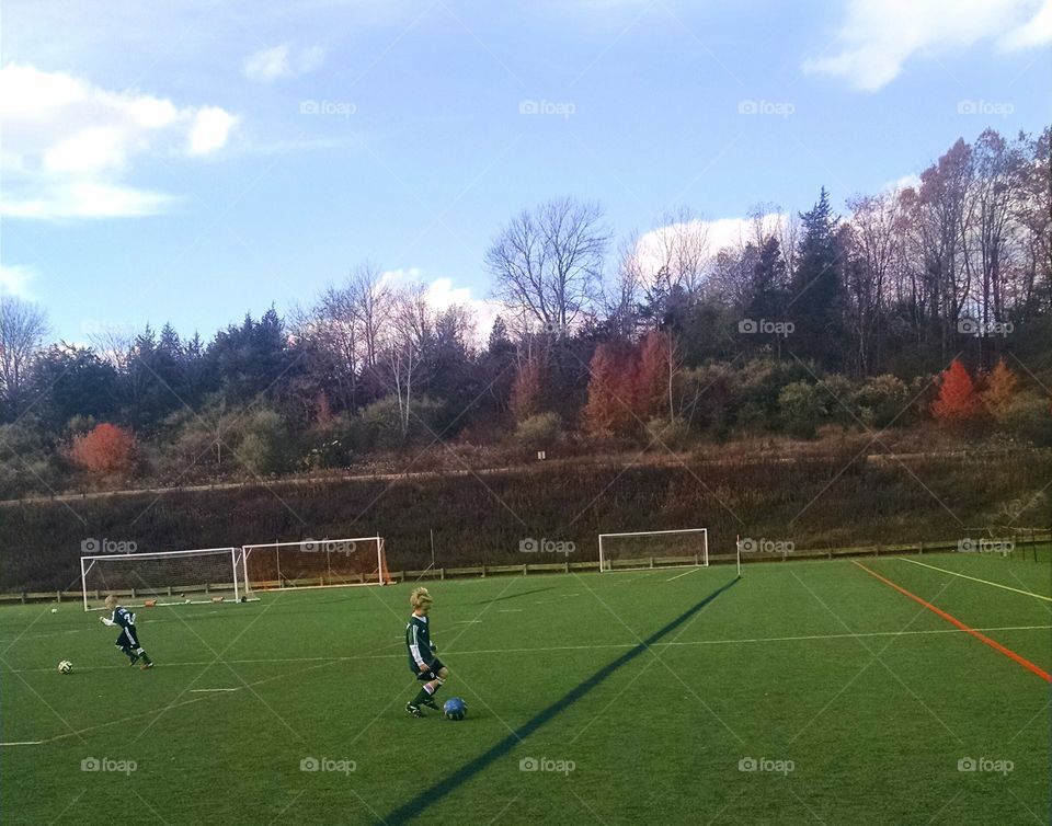 Soccer game on turf. Tristan's soccer game playing on turf, away