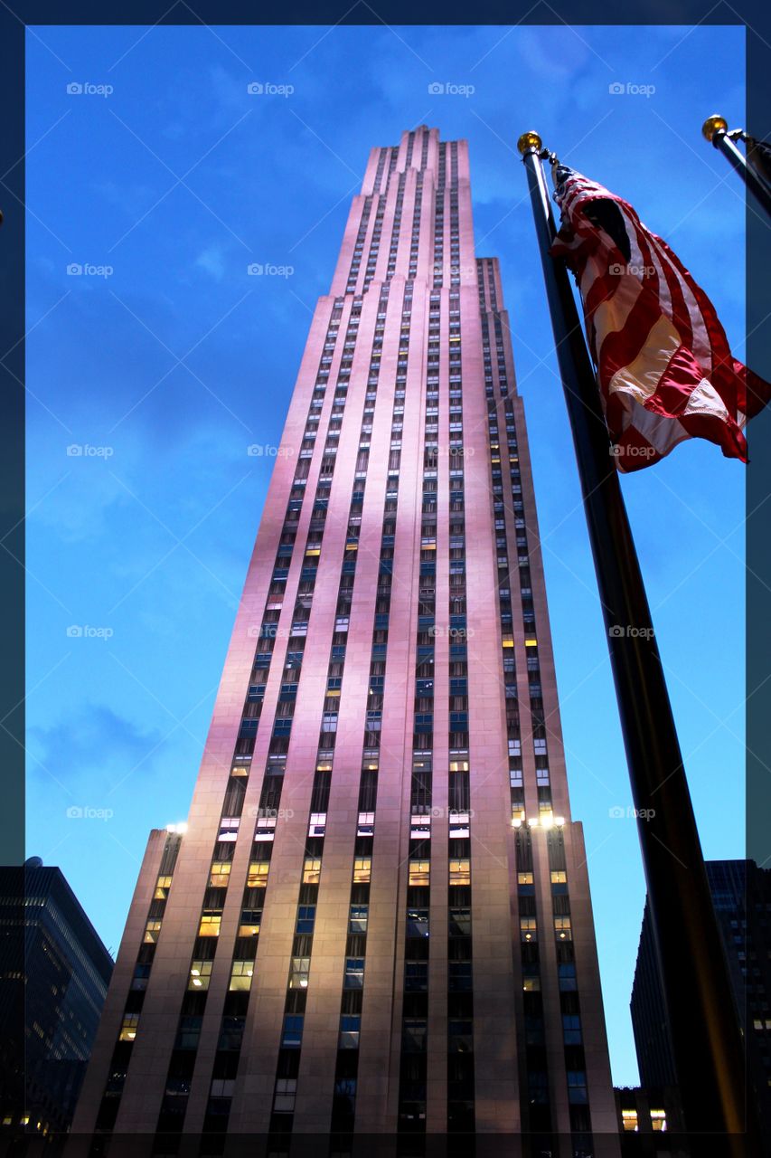 Picture of a building in New York City with the American flag