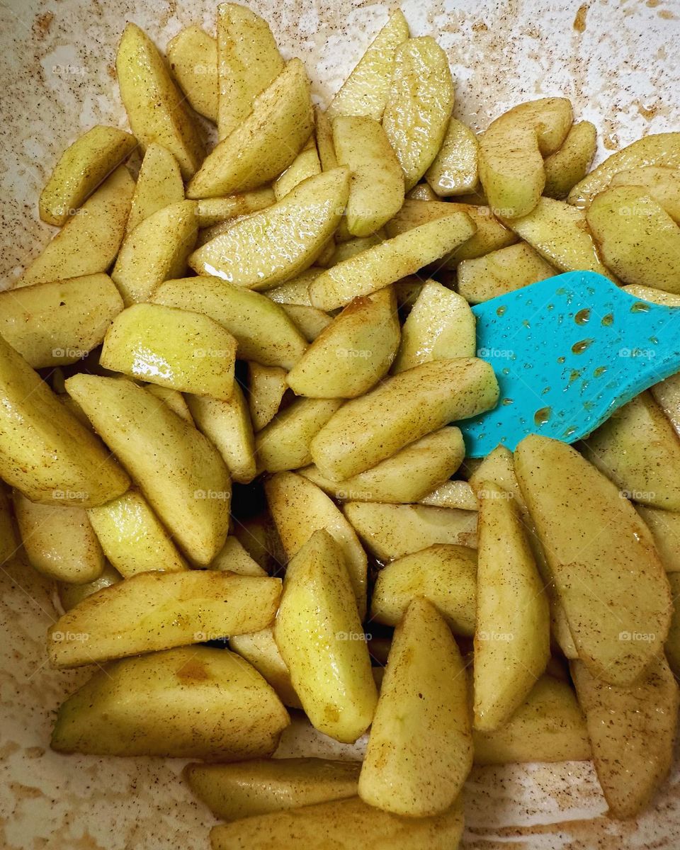Apples with all the spices and sugar to go into an apple pie!