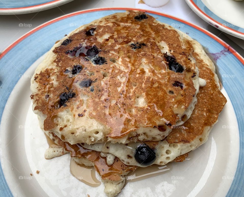 Blueberry pancakes for breakfast in a colorful plate. Tasty, delicious, healthy and yummy food. 