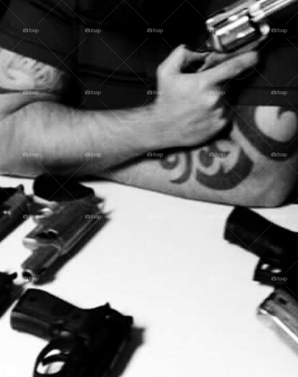 Tattoos and guns 
