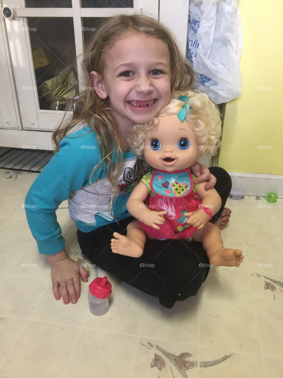 Smiling girl with her doll